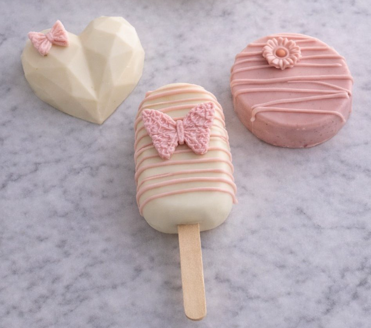 Dipped treats — Oreos, cakesicles, chocolate hearts, strawberries, and rice krispie treats